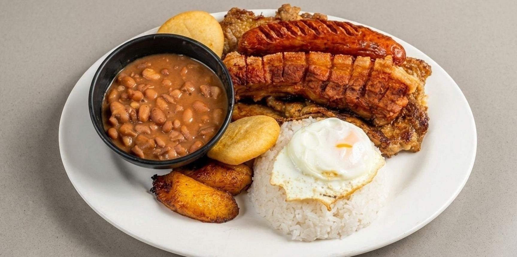 Bandeja paisa with chicharrón, chorizo, carne asada, rice, beans, egg, and plantain